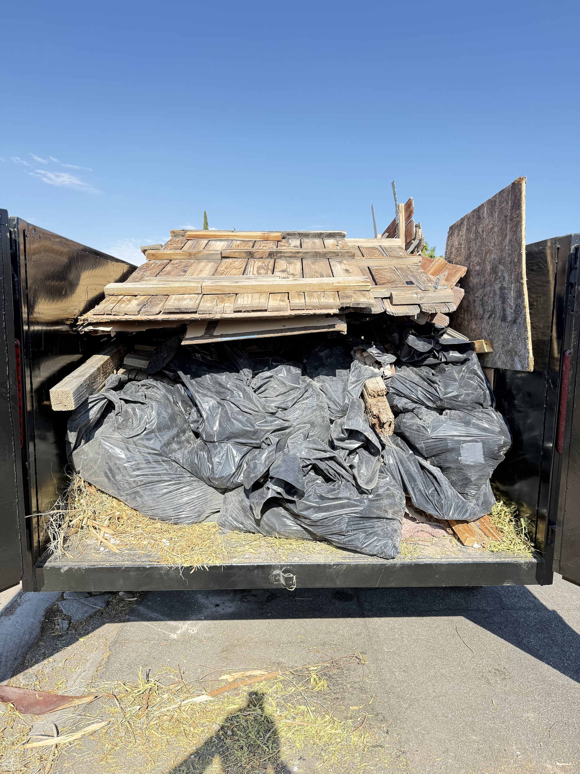Construction wood debris loaded into a Legacy Removal Company trailer