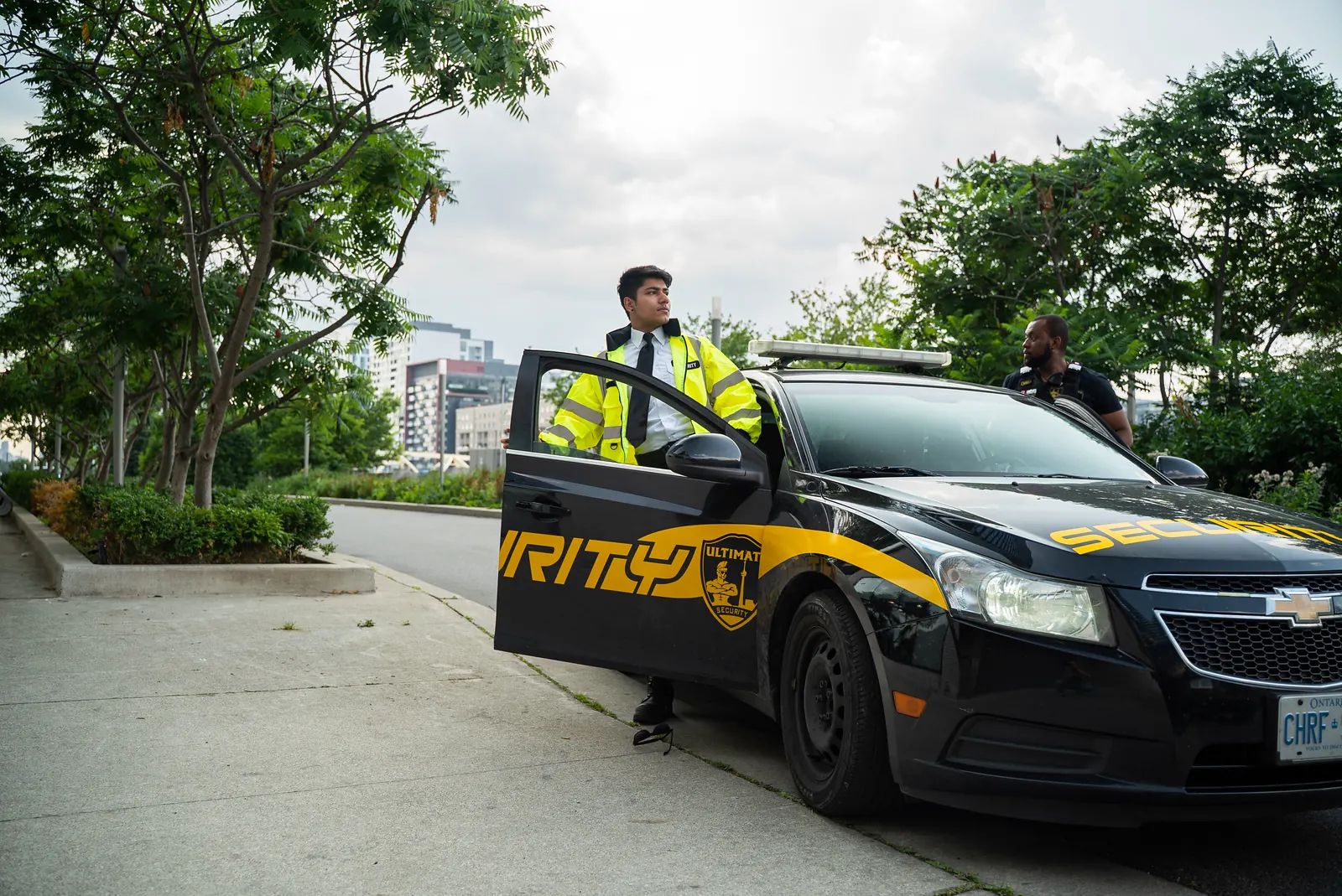 Security officer stepping out of a marked patrol car