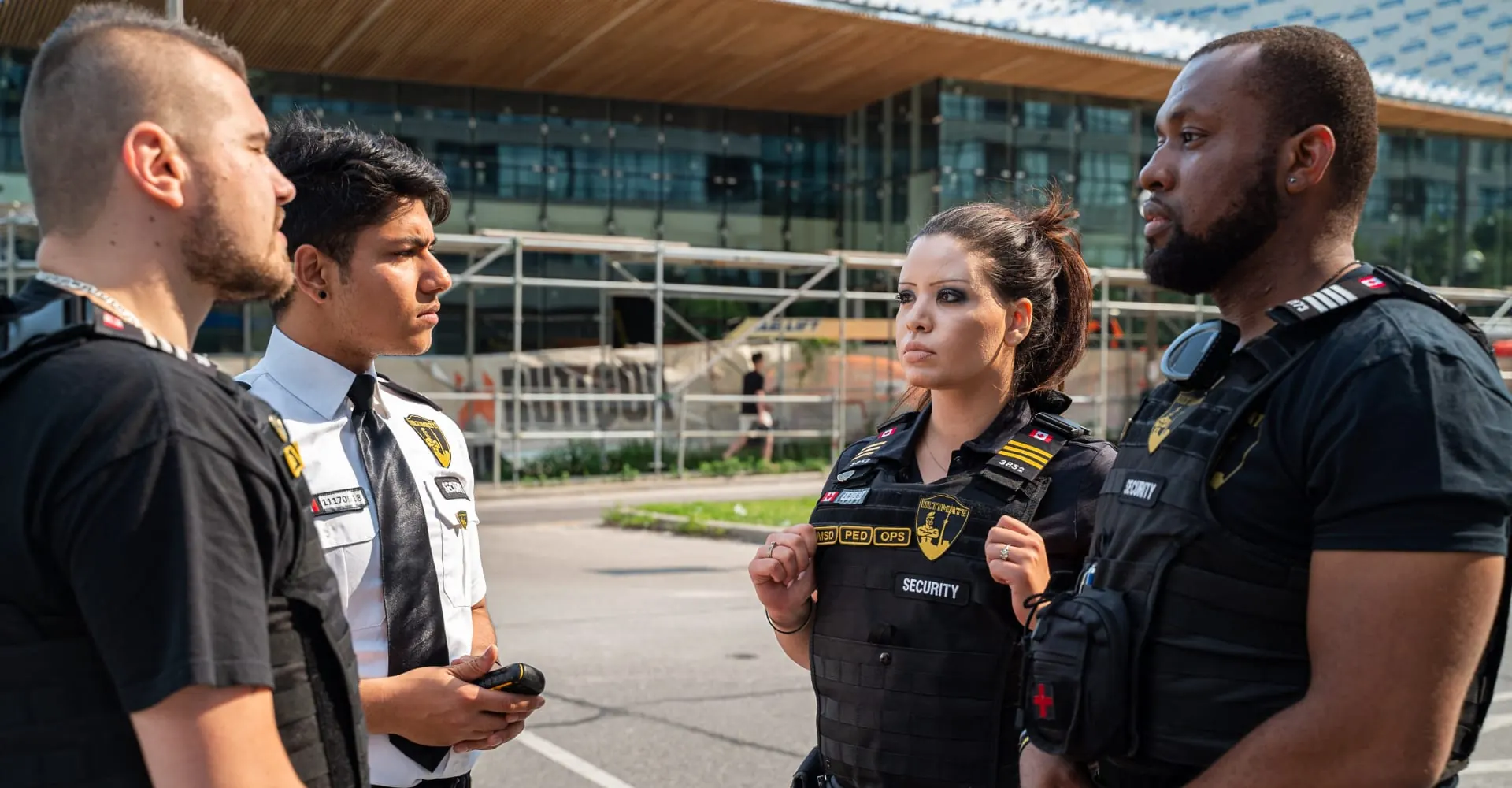 Security officers conferring in front of a building under construction