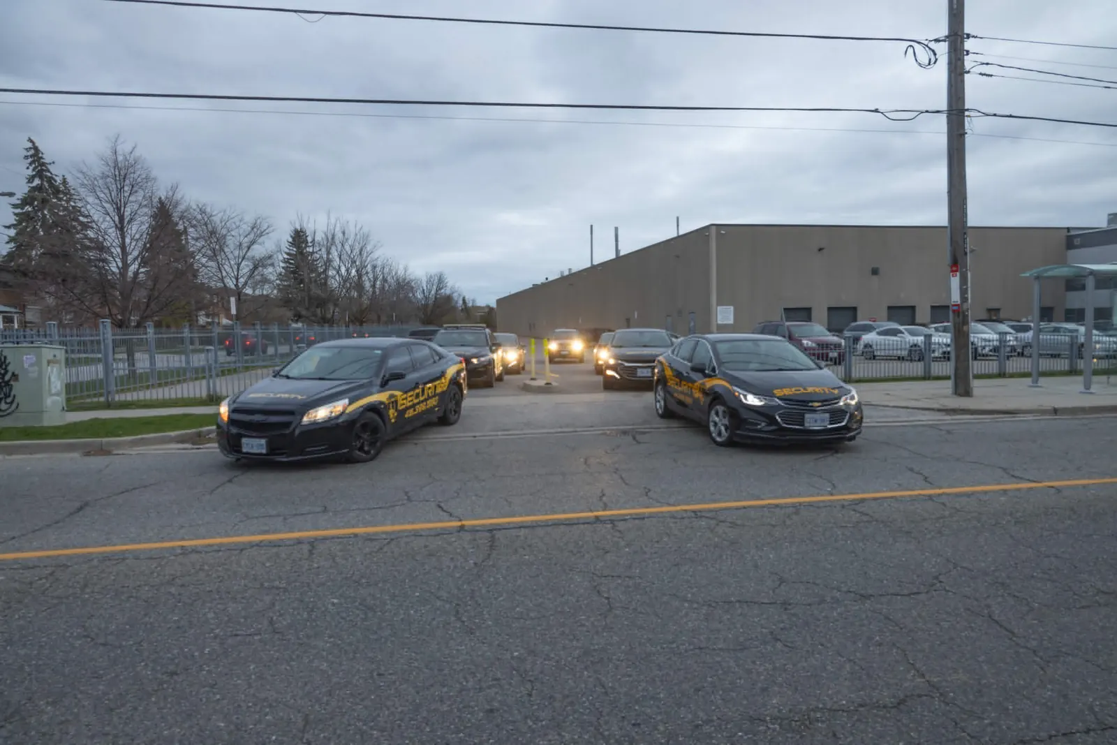 Patrol vehicles in a commercial lot at dusk