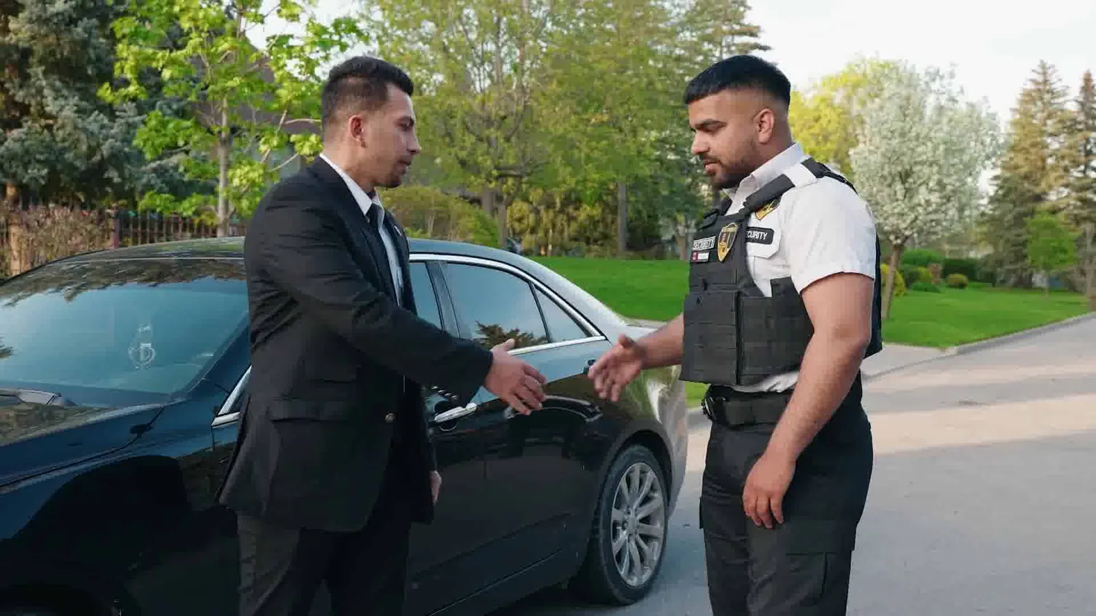 An Ultimate Security officer shaking hands with a client
