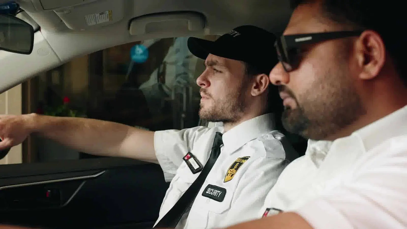 Two officers on patrol inside a vehicle