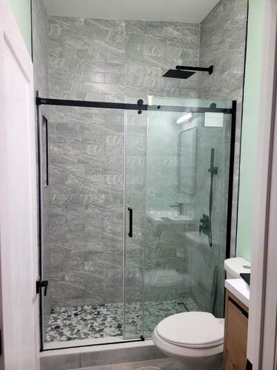 Contemporary shower design with sliding glass doors