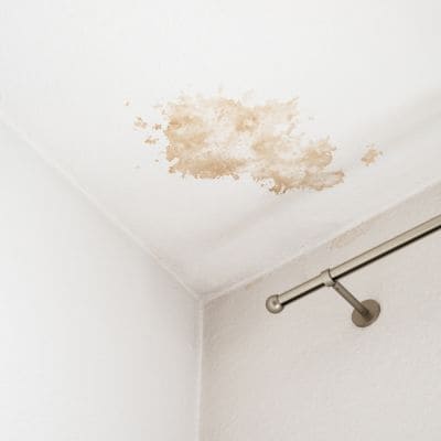 A ceiling with visible water damage stains