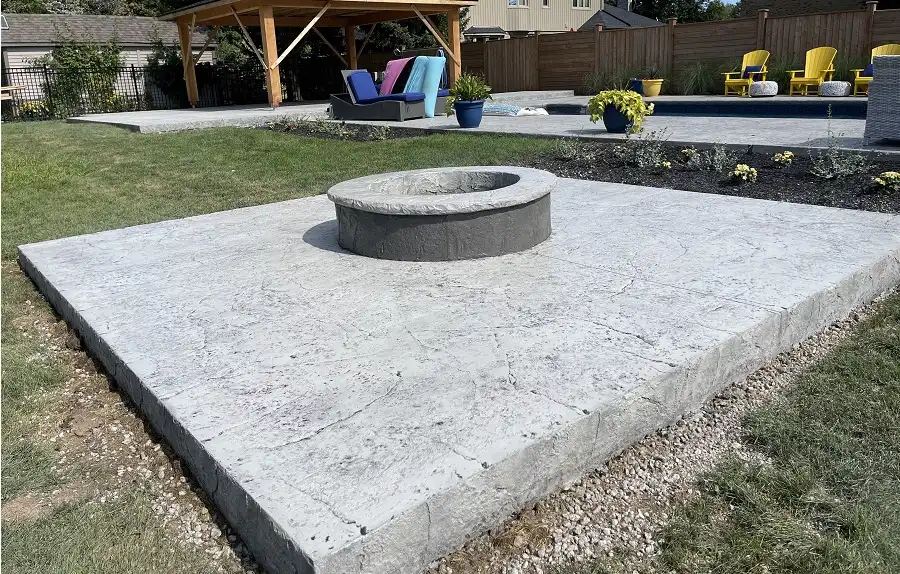 Custom stamped concrete patio and outdoor fire pit project by SCP.