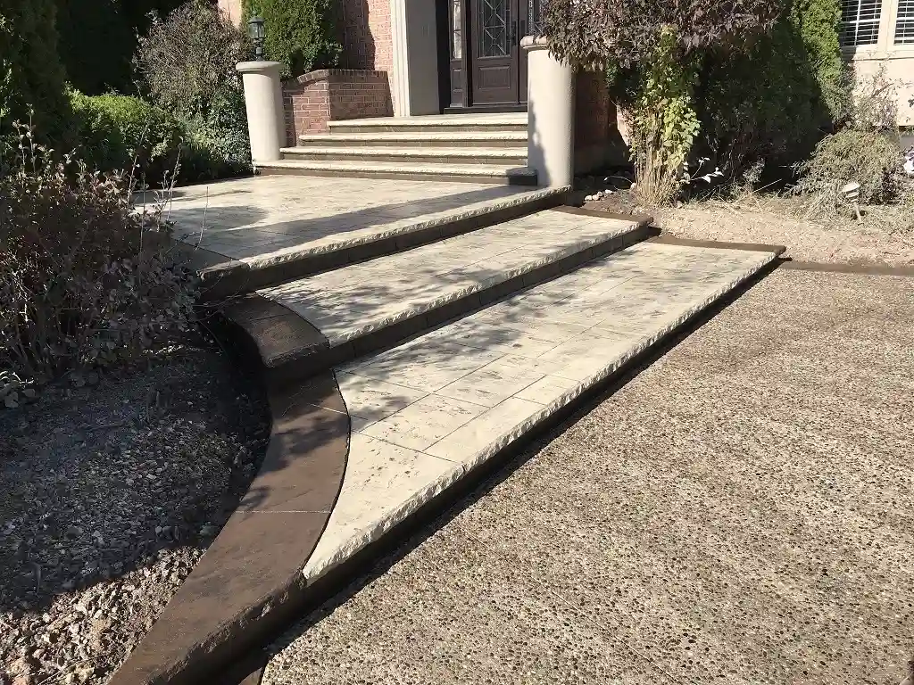 Concrete front entrance and walkway by SCP Stamped Concrete Pros Inc.