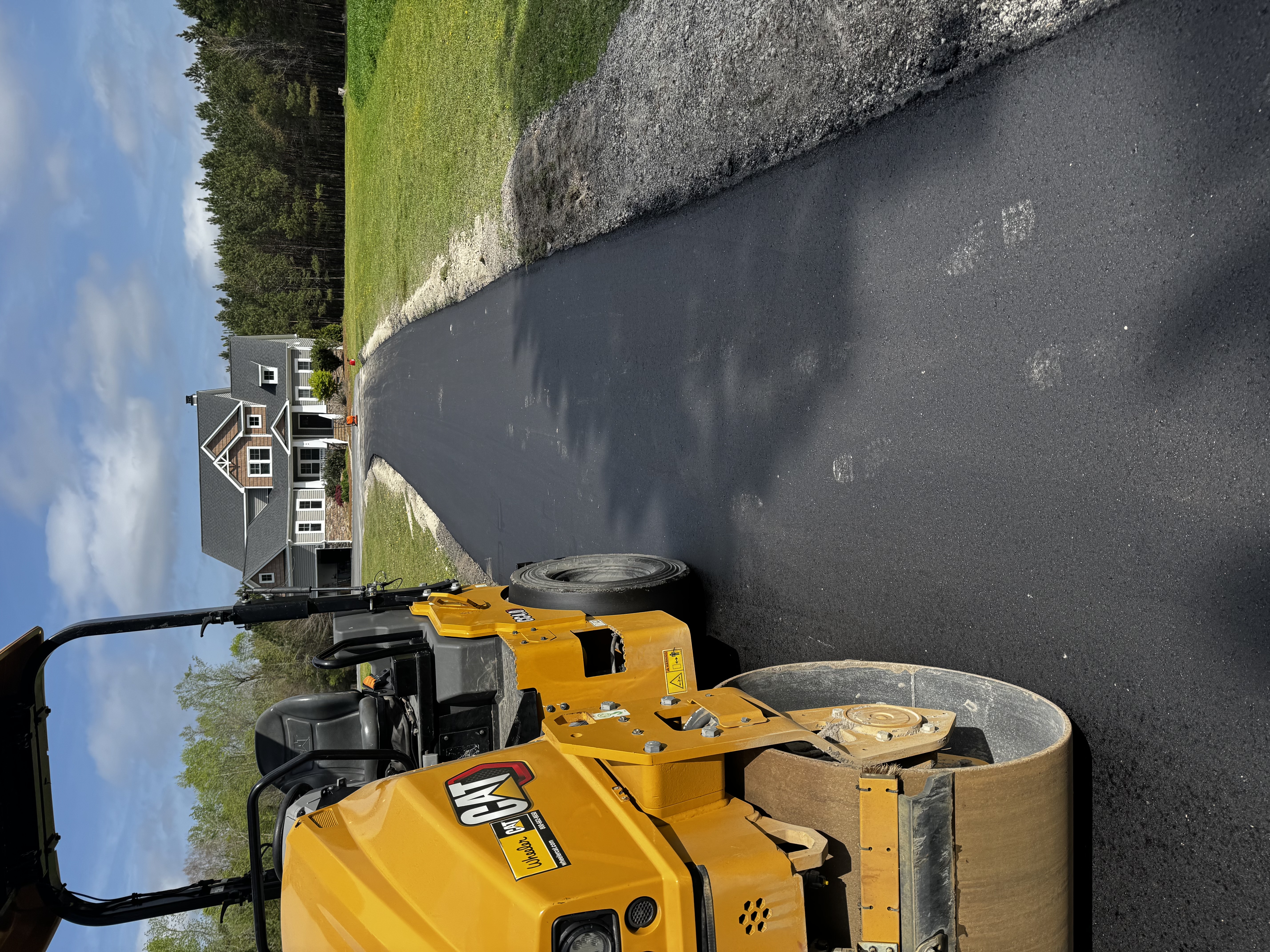 Long asphalt driveway curving up to a Utah home