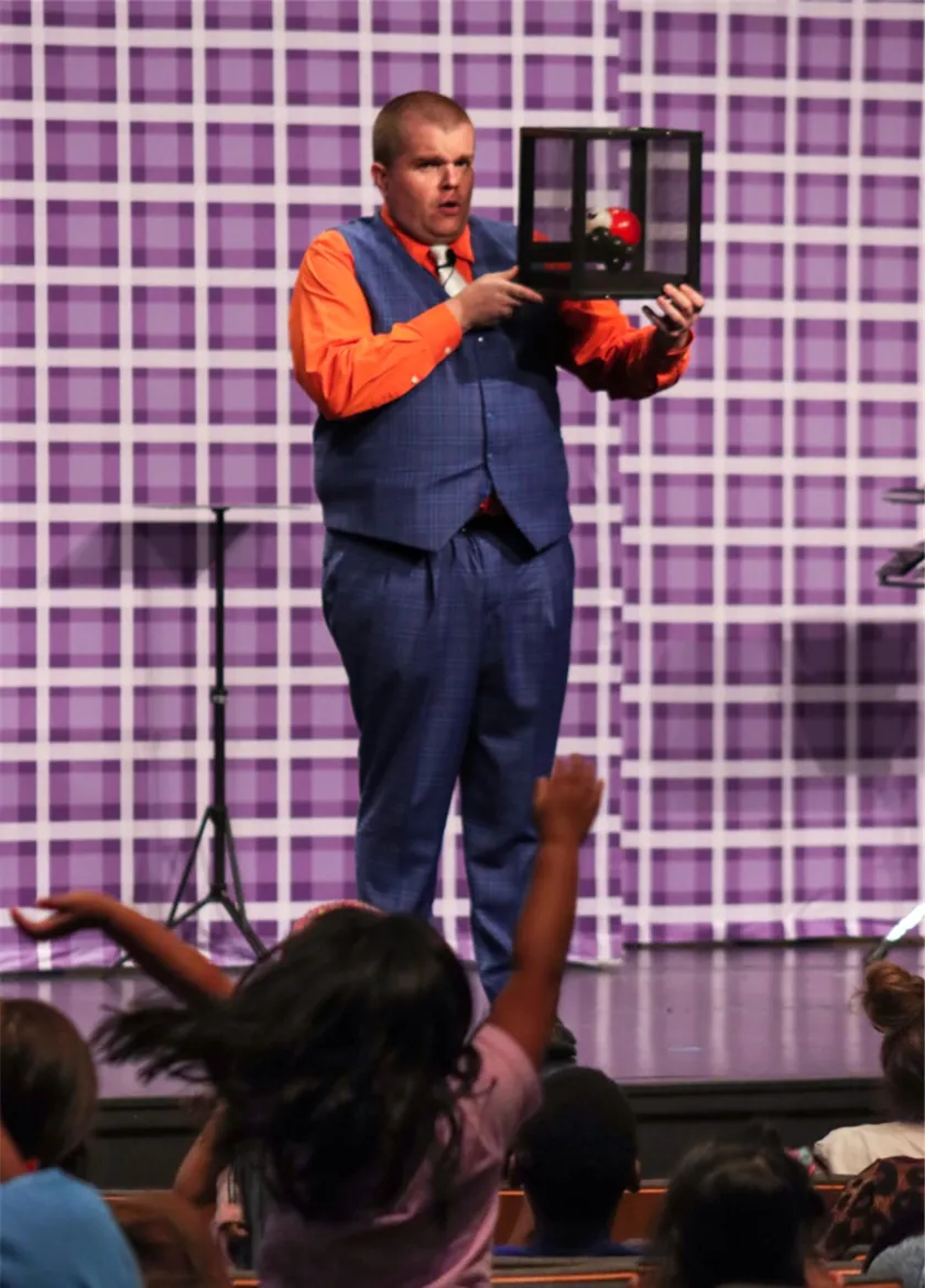 Brettso the Great performing magic on stage