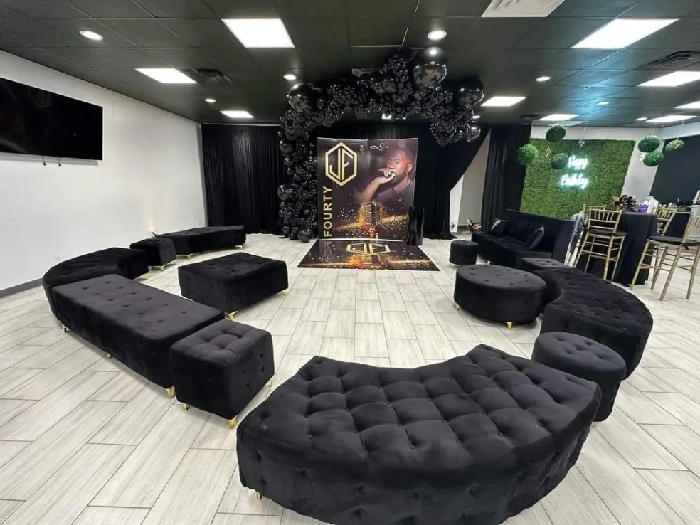 A black and gold lounge seating area arranged near the entrance
