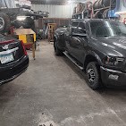 Inside Mundt's Auto shop in Good Thunder, MN, with vehicles ready for service