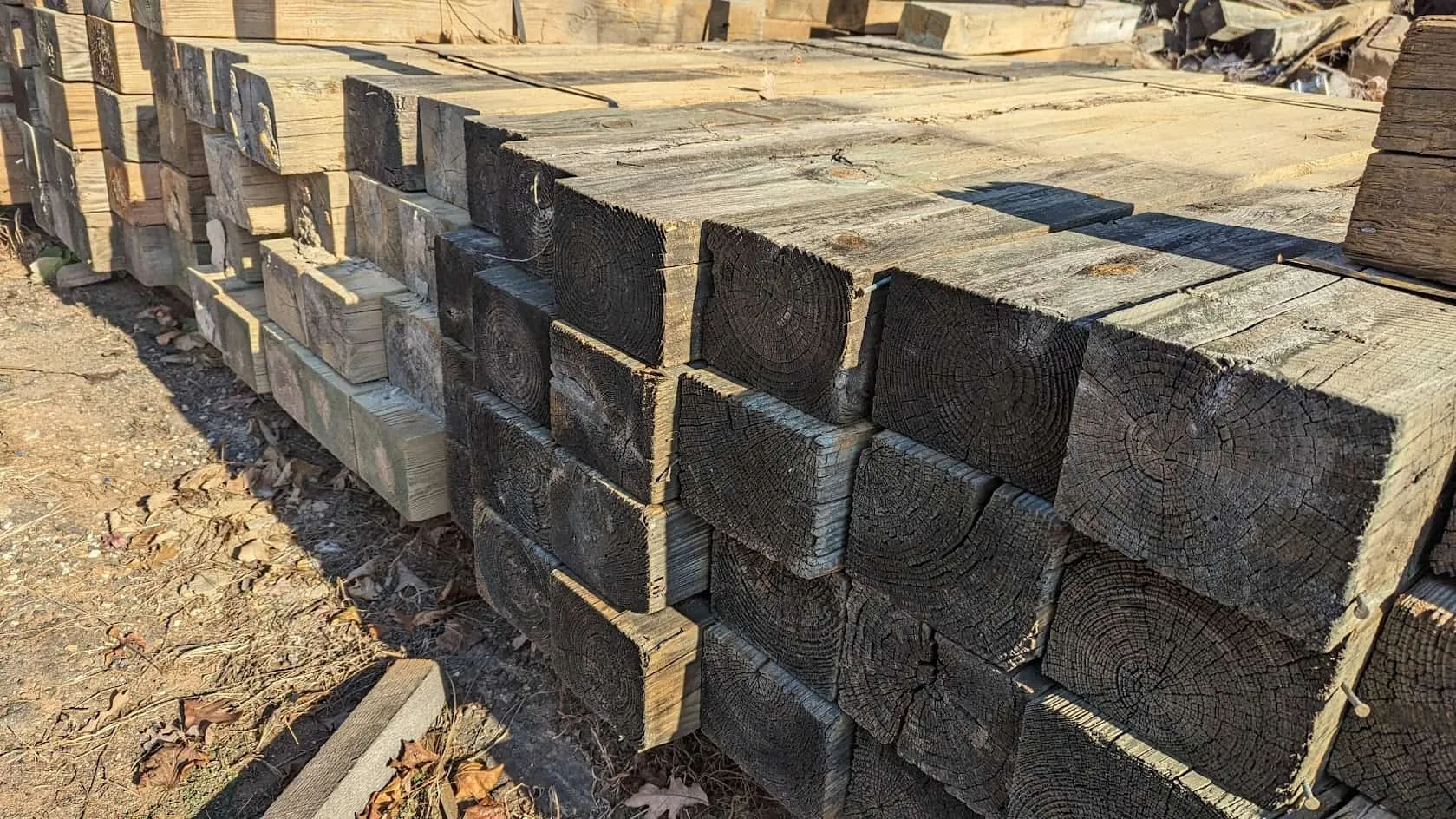 Stack of recycled guardrail timbers