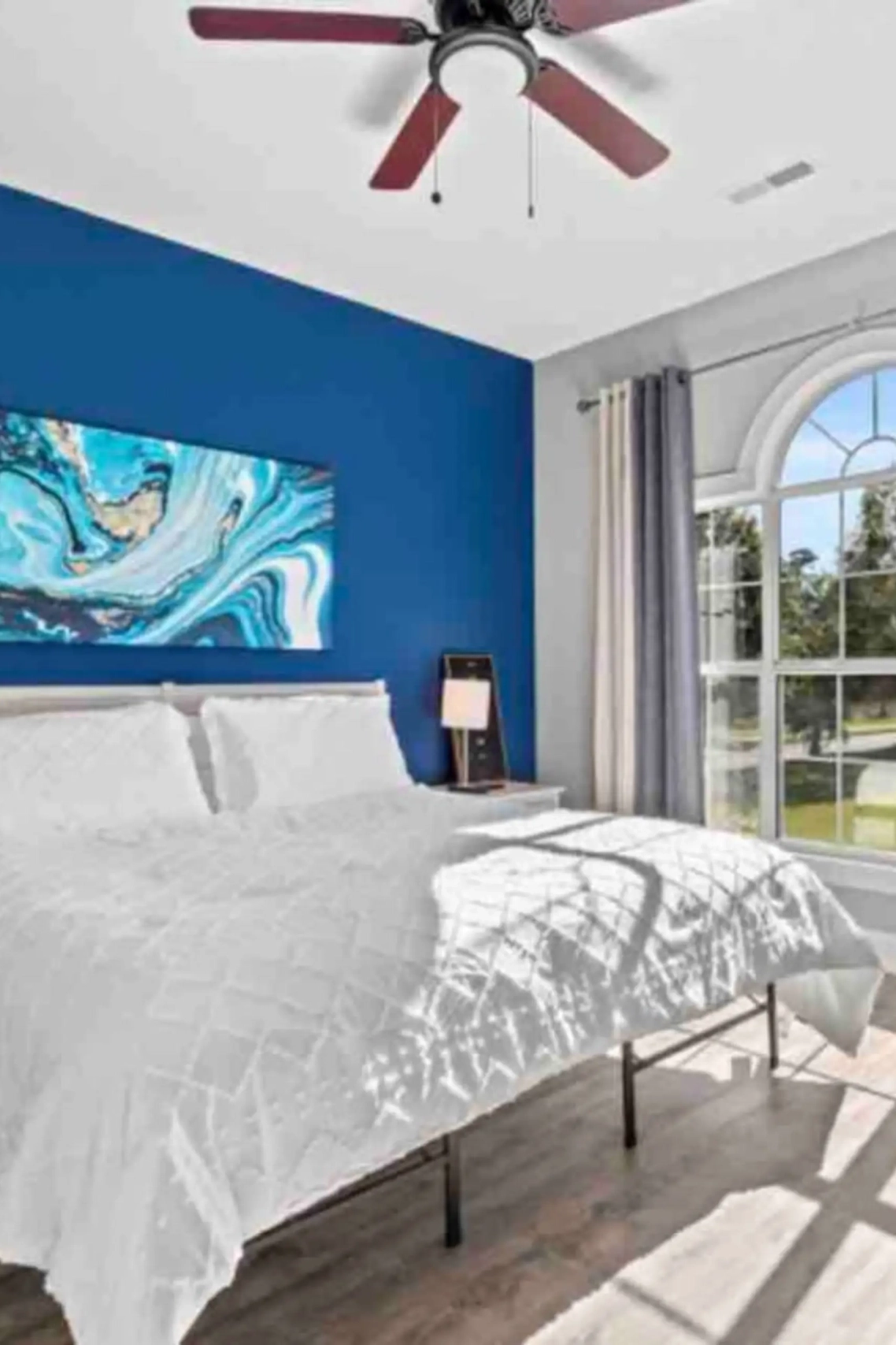 woman setting sheets on bed