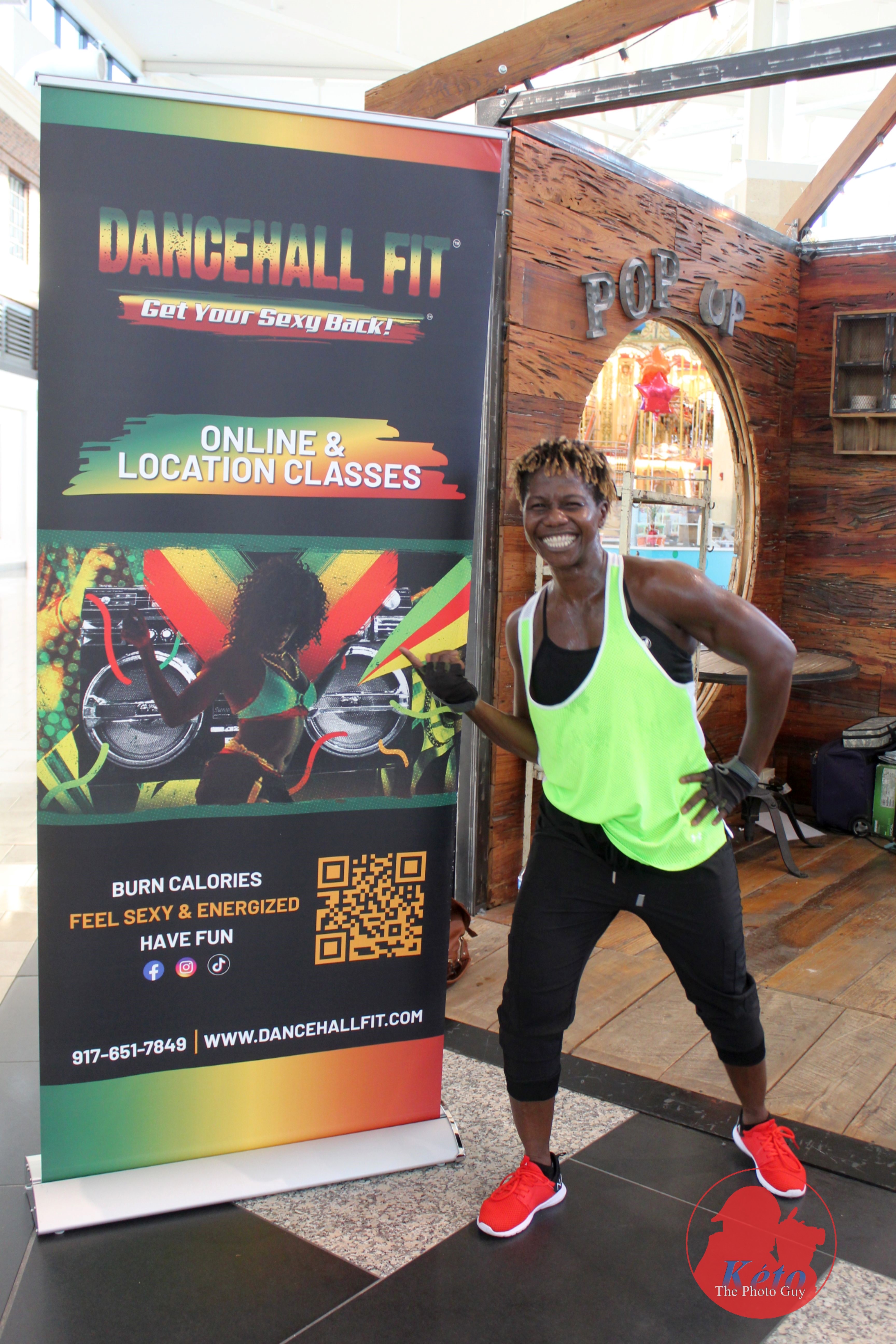 Chinyere Sam beside the Dancehall Fit pop-up banner