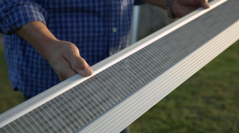 Technician holding the Leaf Armor gutter guard product