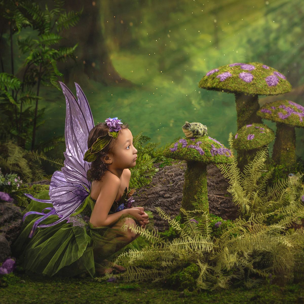Fairy girl watching a frog on a moss mushroom
