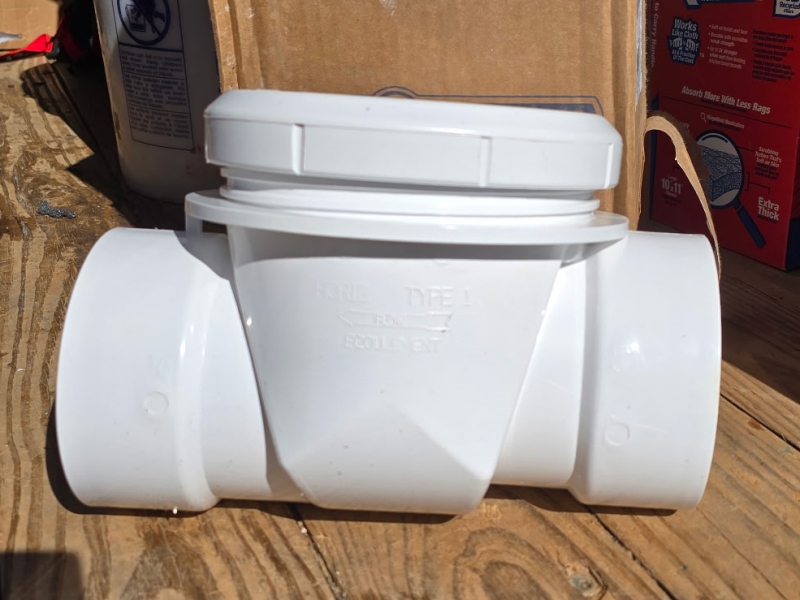 A backwater valve, side view, uninstalled, to showcase what the plumbing part looks like