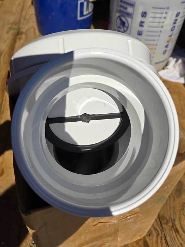 A backwater valve, showing the inside of with the flap open