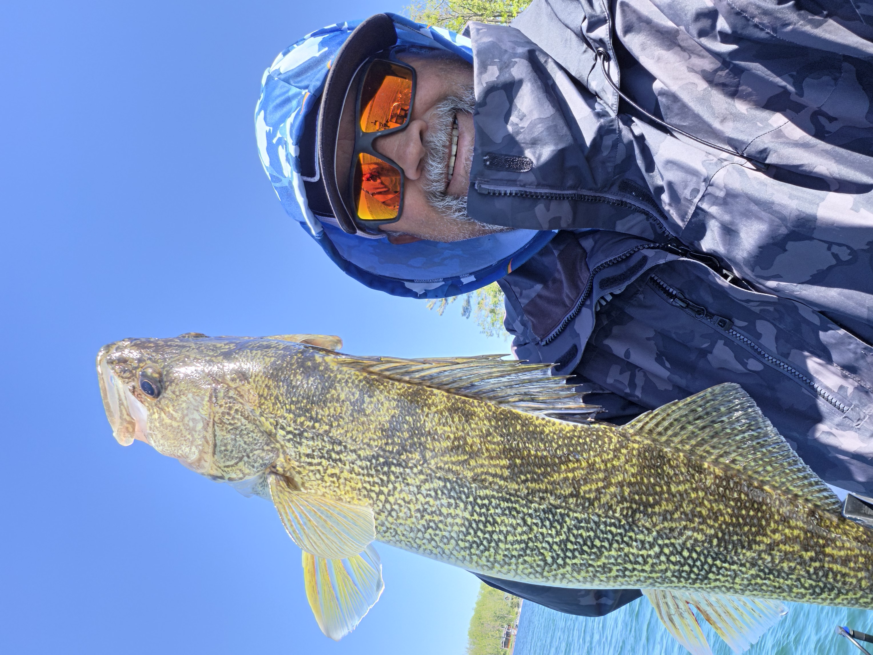 Angler holding a walleye catch aboard CLK Charters