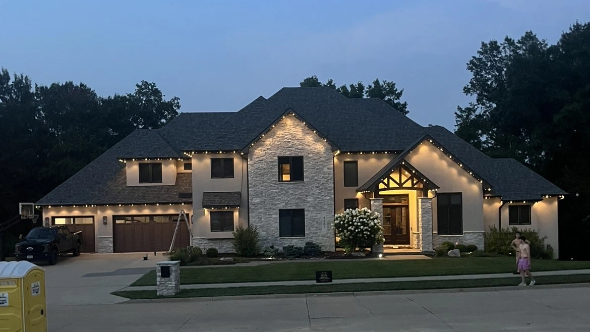 Mid Mo Glow permanent lighting glowing on a home at dusk