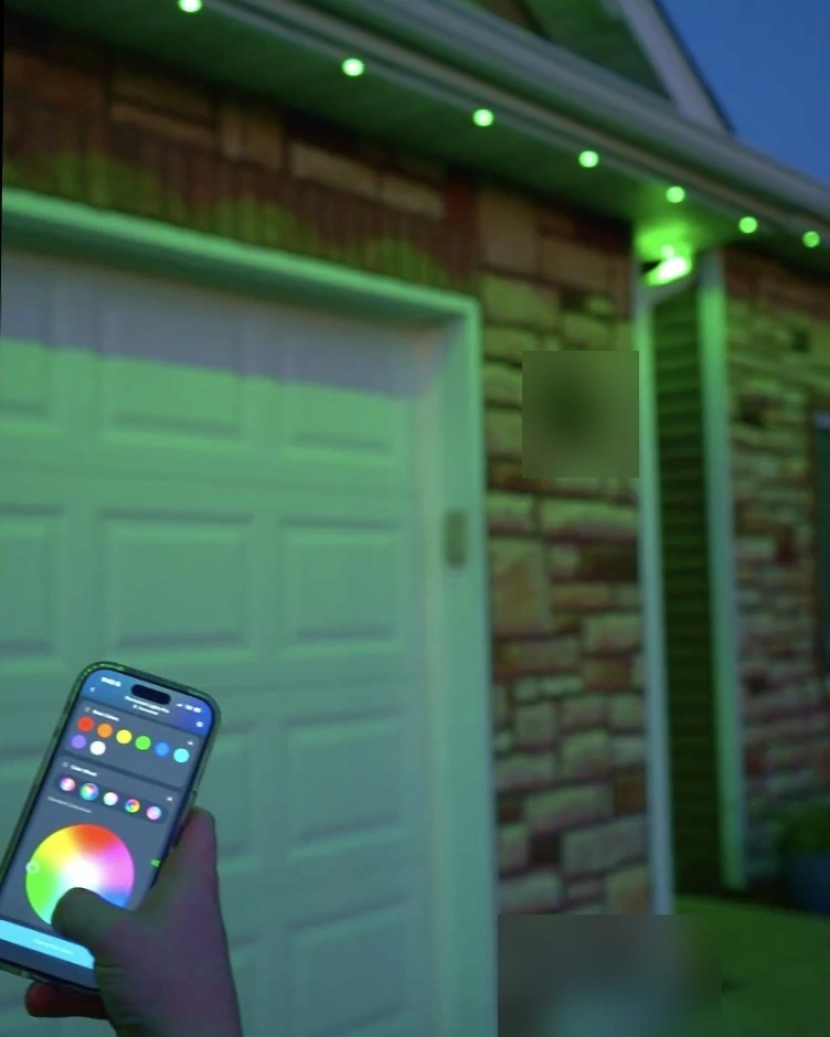 Phone app controlling green permanent lights on a home