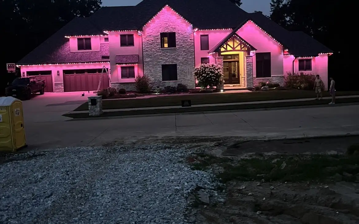Brick home outlined in bright white permanent lights at night