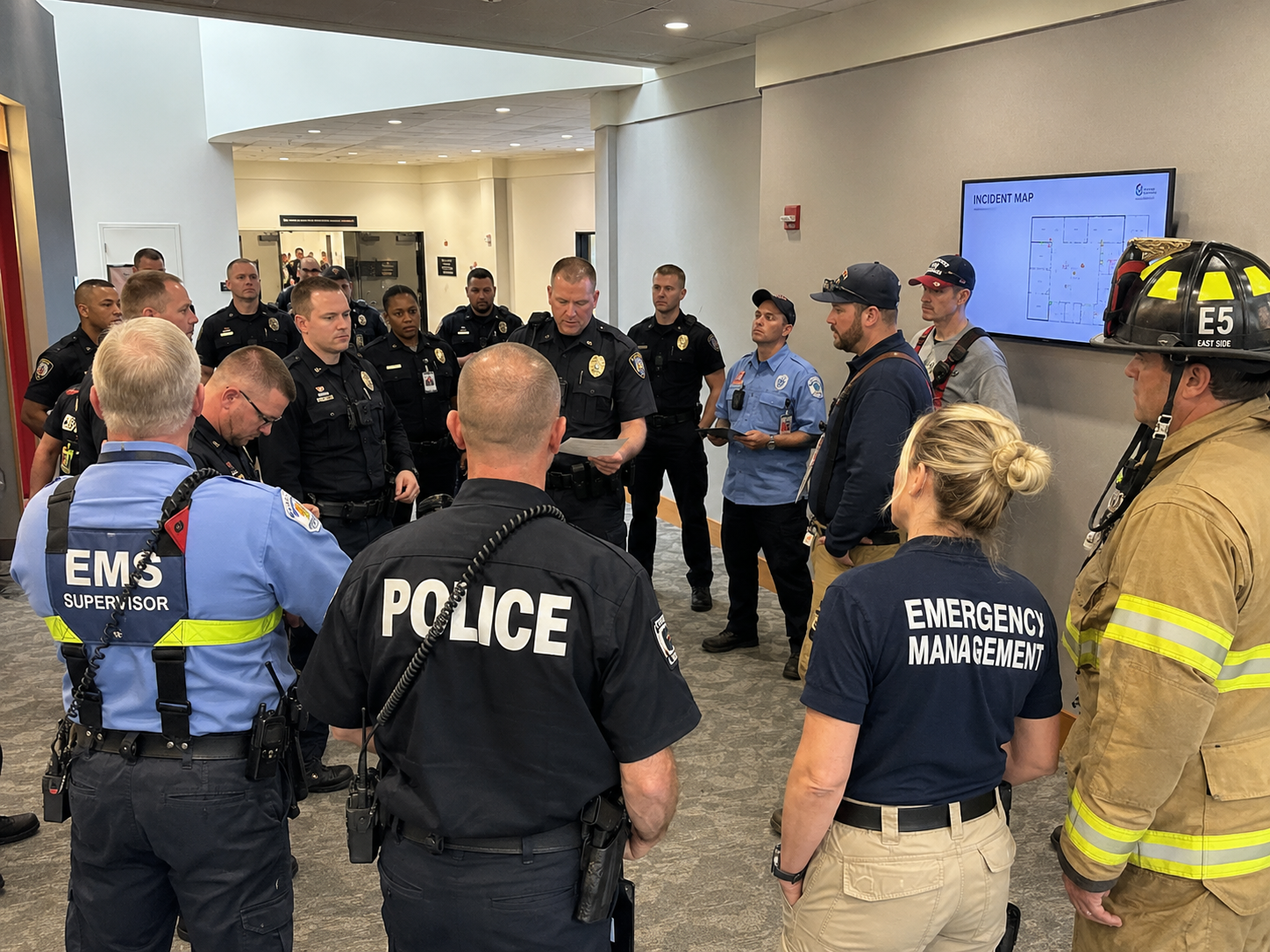 Law enforcement, EMS, fire, and emergency management personnel preparing together during a joint high-threat response exercise Law enforcement, EMS, fire, and emergency management personnel preparing together during a joint high-threat response exercise