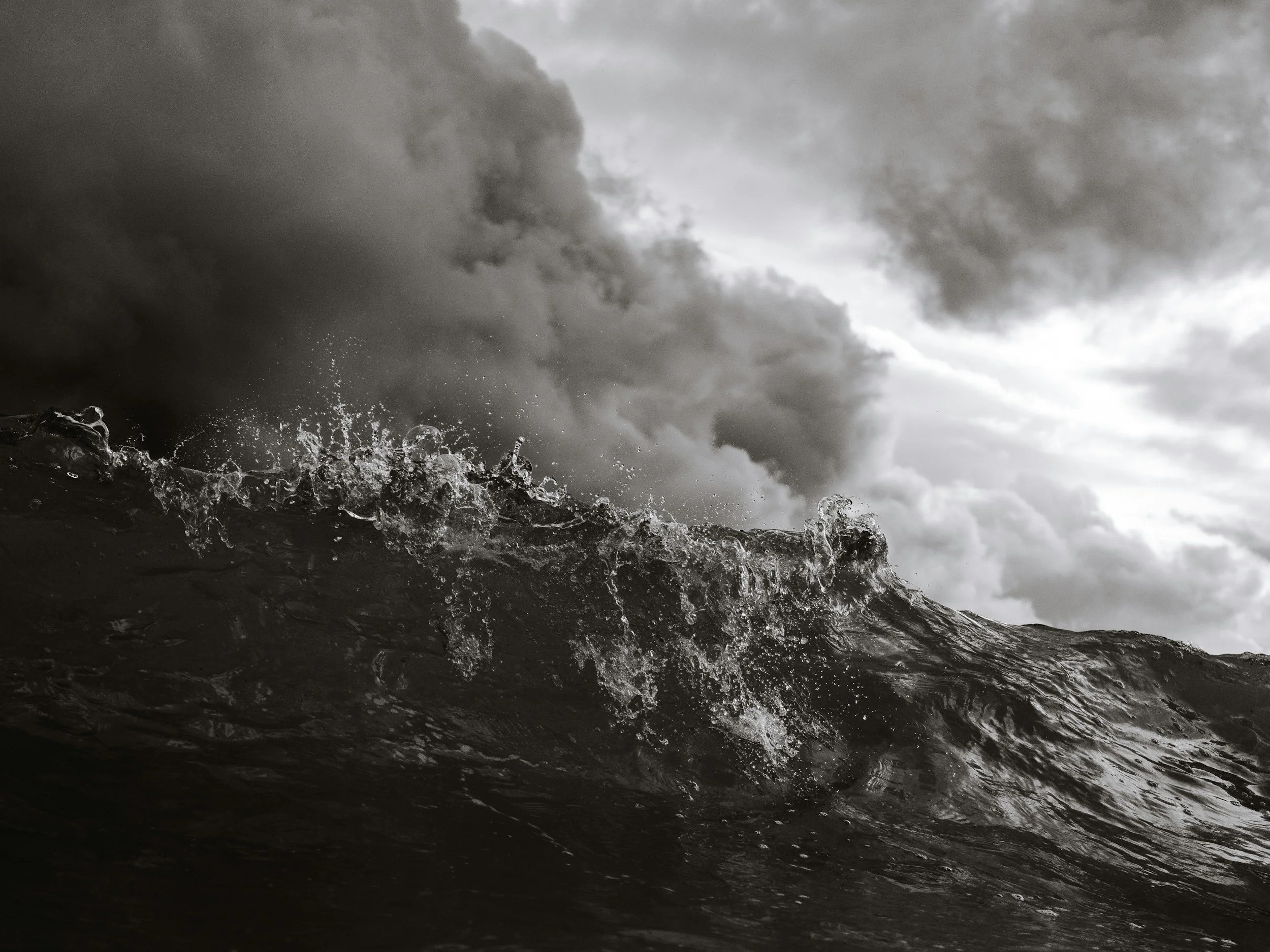 Calm ocean water beneath a gathering storm