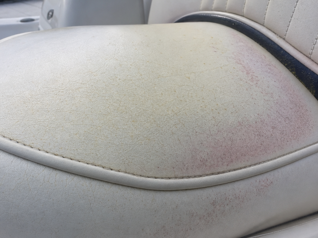 Marine vinyl boat seat showing UV cracking and Pink Stain — My Upholstery Guys Fort Worth