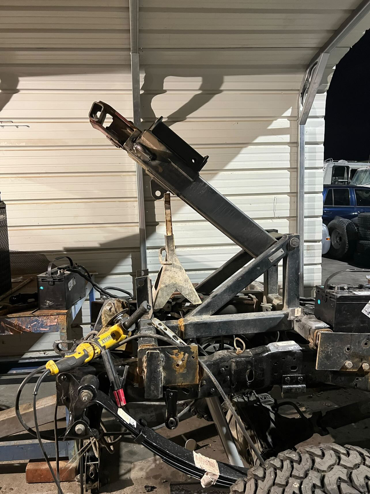 Custom fabricated dump trailer hoist mechanism with hydraulic components, welded and assembled in-shop