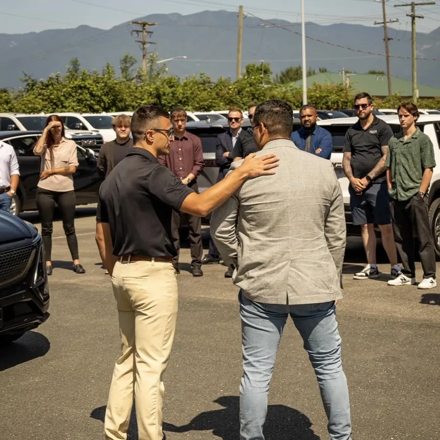 Russ on a dealership lot with the sales team