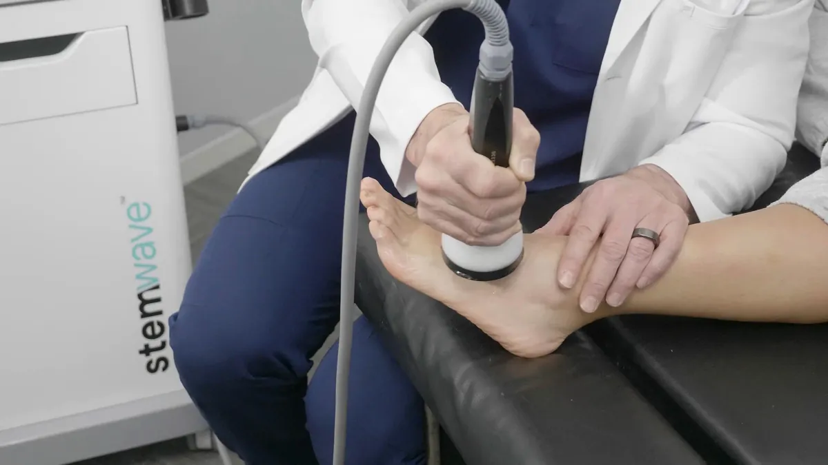 StemWave applicator on the sole of the foot during a heel treatment