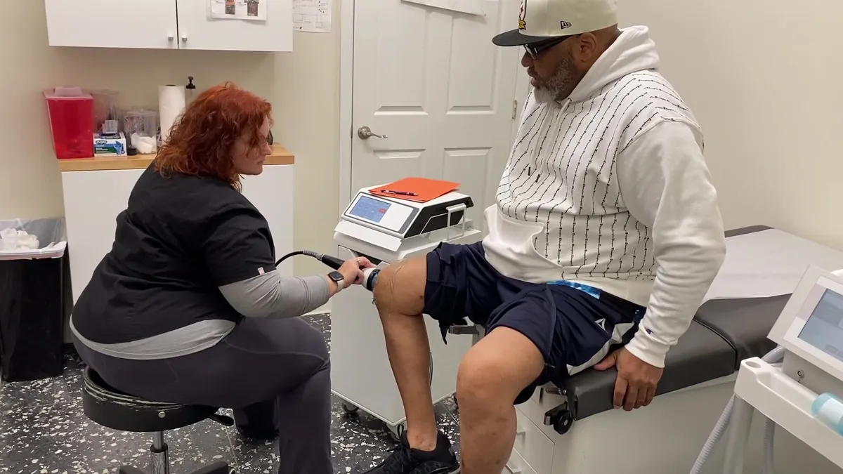 StemWave treatment on the side of a patient's knee