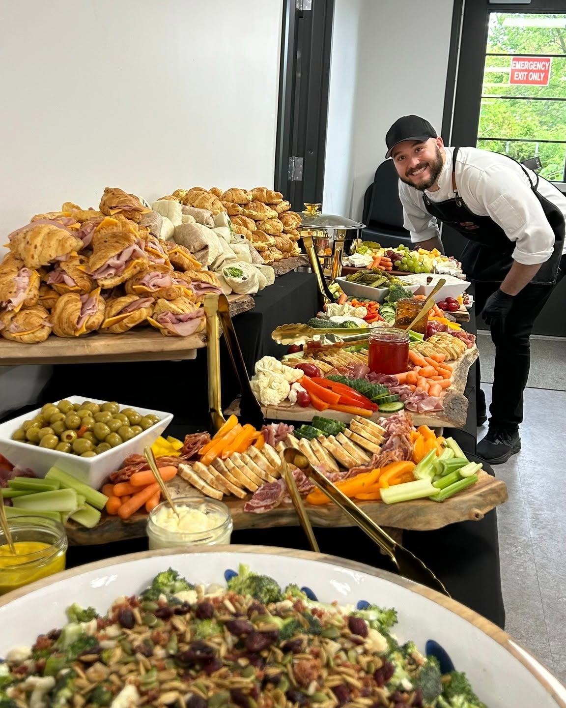 Chef Seb standing beside a table full of prepared dishes