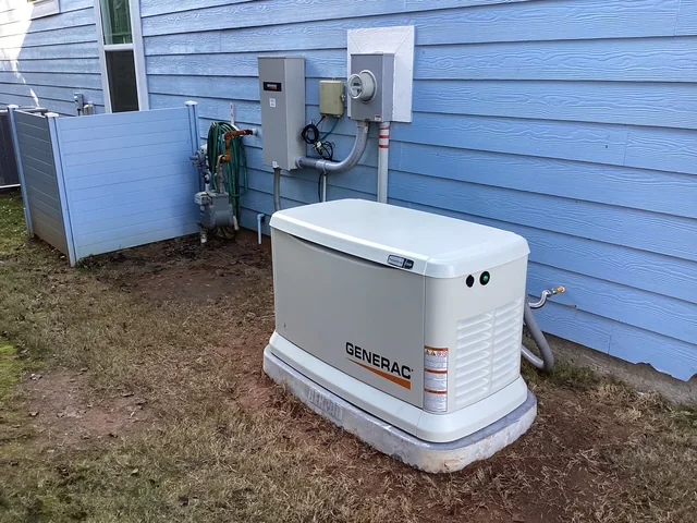 A Generac standby generator installed beside a blue home, from the APS project gallery