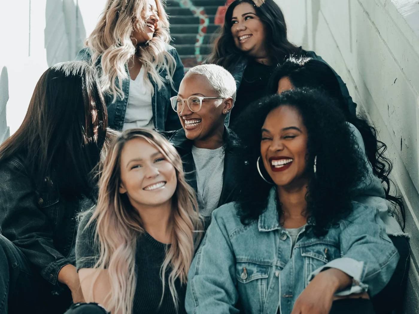 A group of women gathered together, smiling