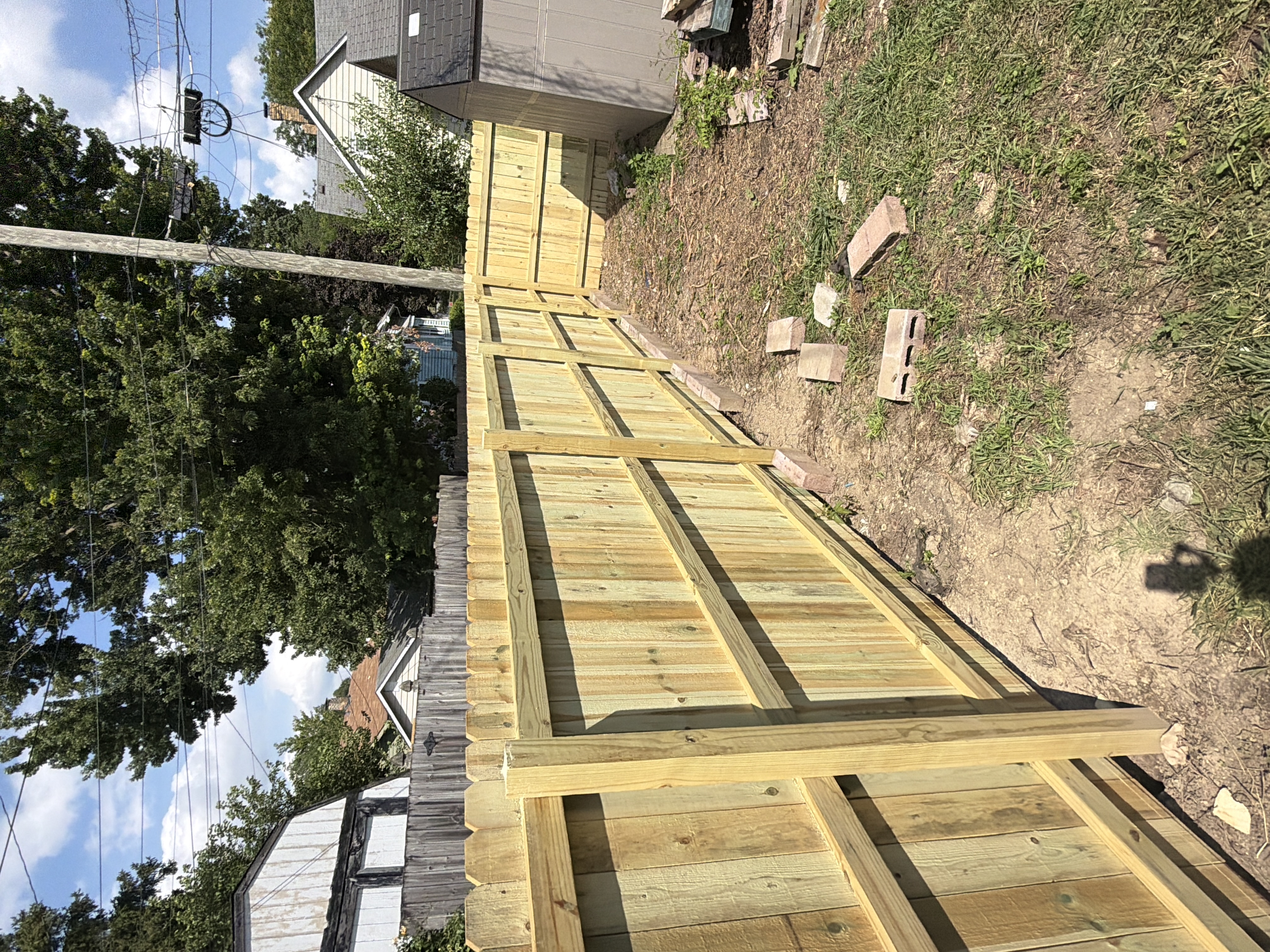 New cedar privacy fence installed along a backyard property line