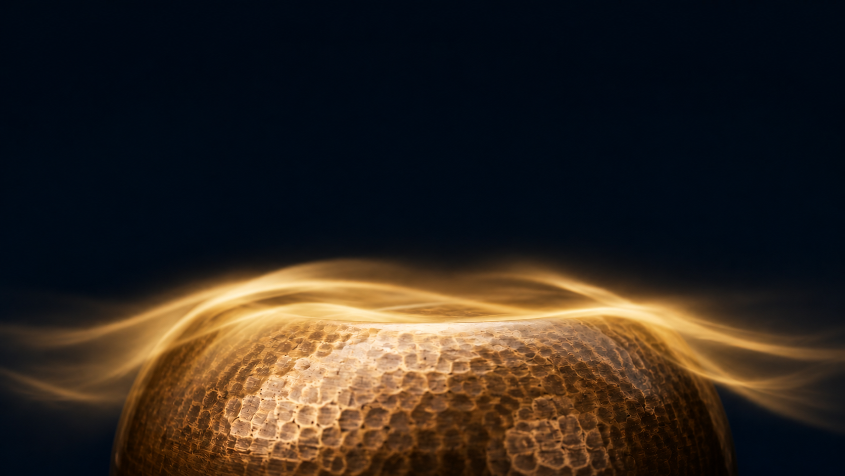 A close-up Tibetan Singing Bowl illuminated with warm golden light