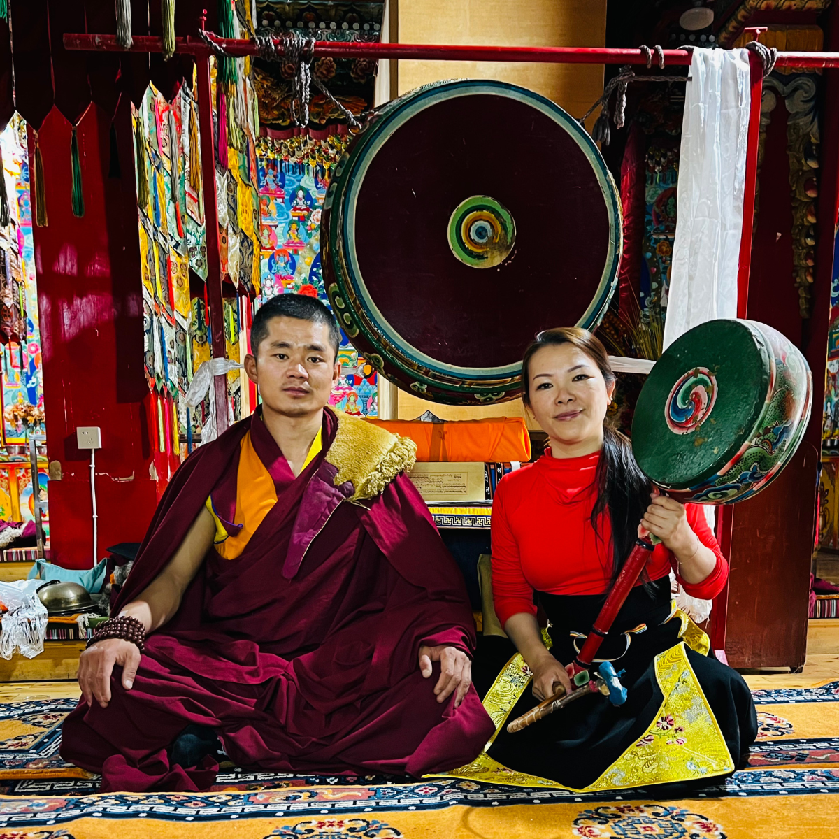 Riya Wang studying in Tibet with a Tibetan monk and traditional instruments
