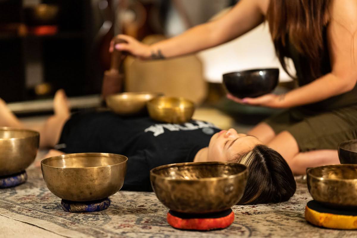A student receiving a complete Tibetan Singing Bowl sound session