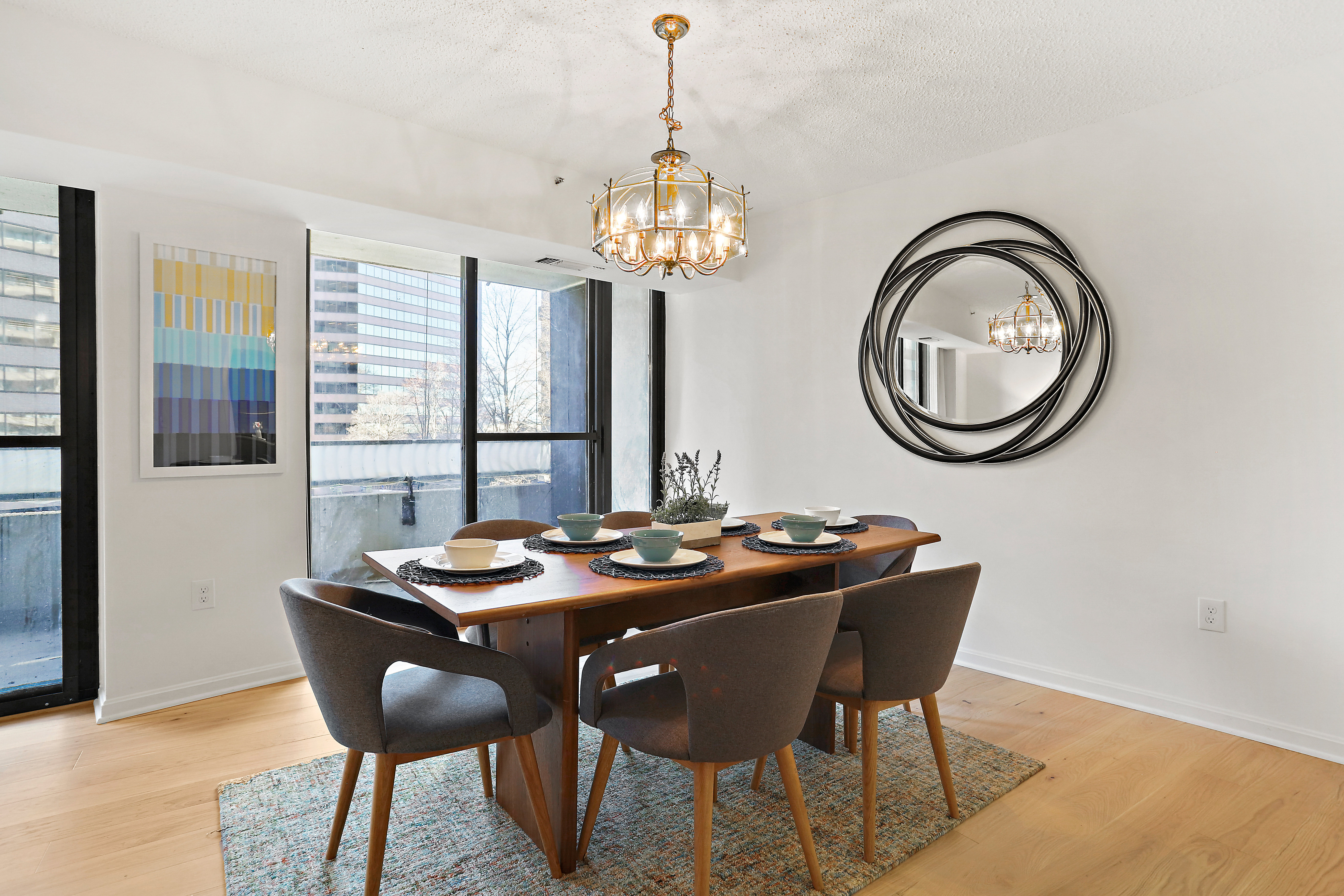 professional photorealistic view of a bright, freshly painted living room in an Ashburn VA home with neutral decor, tasteful staging, and large windows looking toward a tree-lined suburban street, neutral color palette