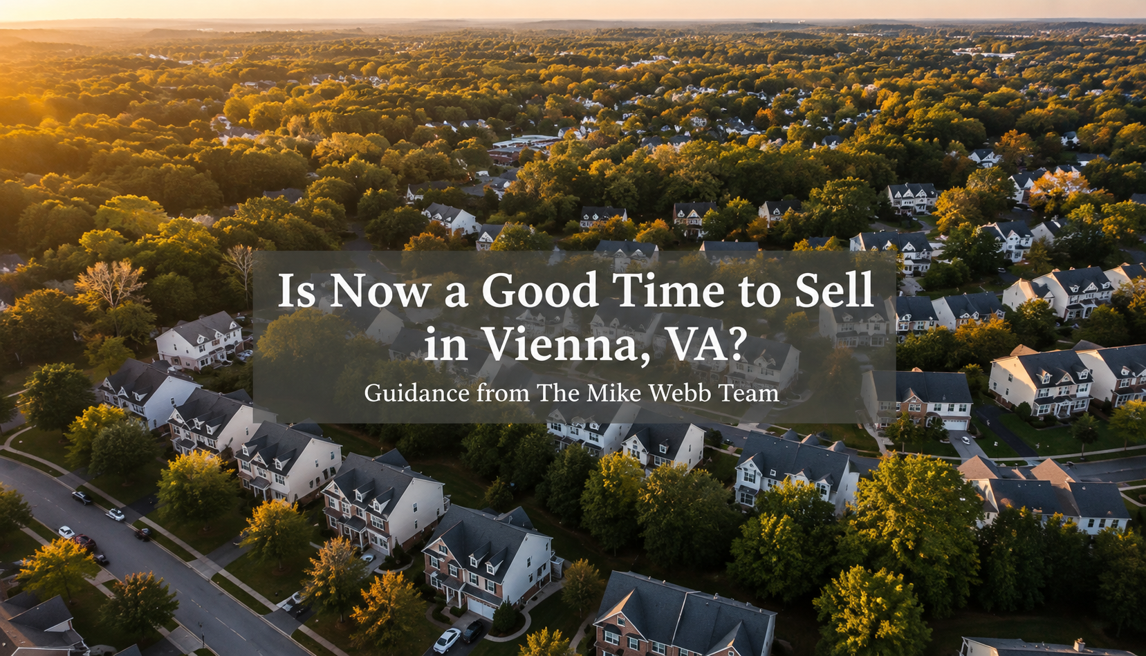 photorealistic aerial view of a tree-lined Vienna VA neighborhood at golden hour, neutral color palette of deep navy roofs and warm ivory homes, subtle text overlay in clean sans-serif font reading 'Is Now a Good Time to Sell in Vienna, VA?' with smaller subtitle 'Guidance from the Mike & Claudia Webb Team'