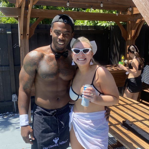 A guest celebrating with her Cheeky Butler on the patio