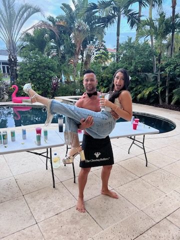 A Cheeky Butler lifting a guest at a pool party