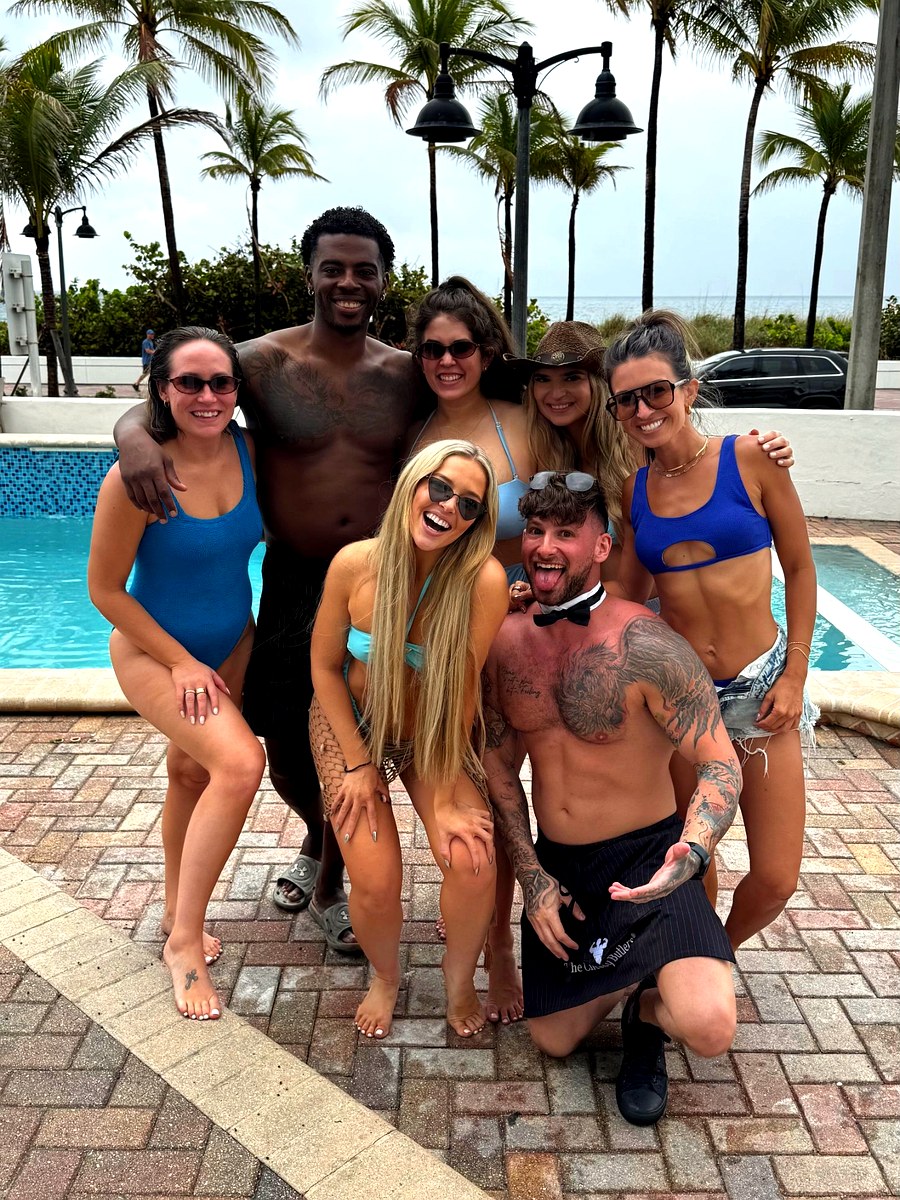 A girls trip group with two Cheeky Butlers by the beach