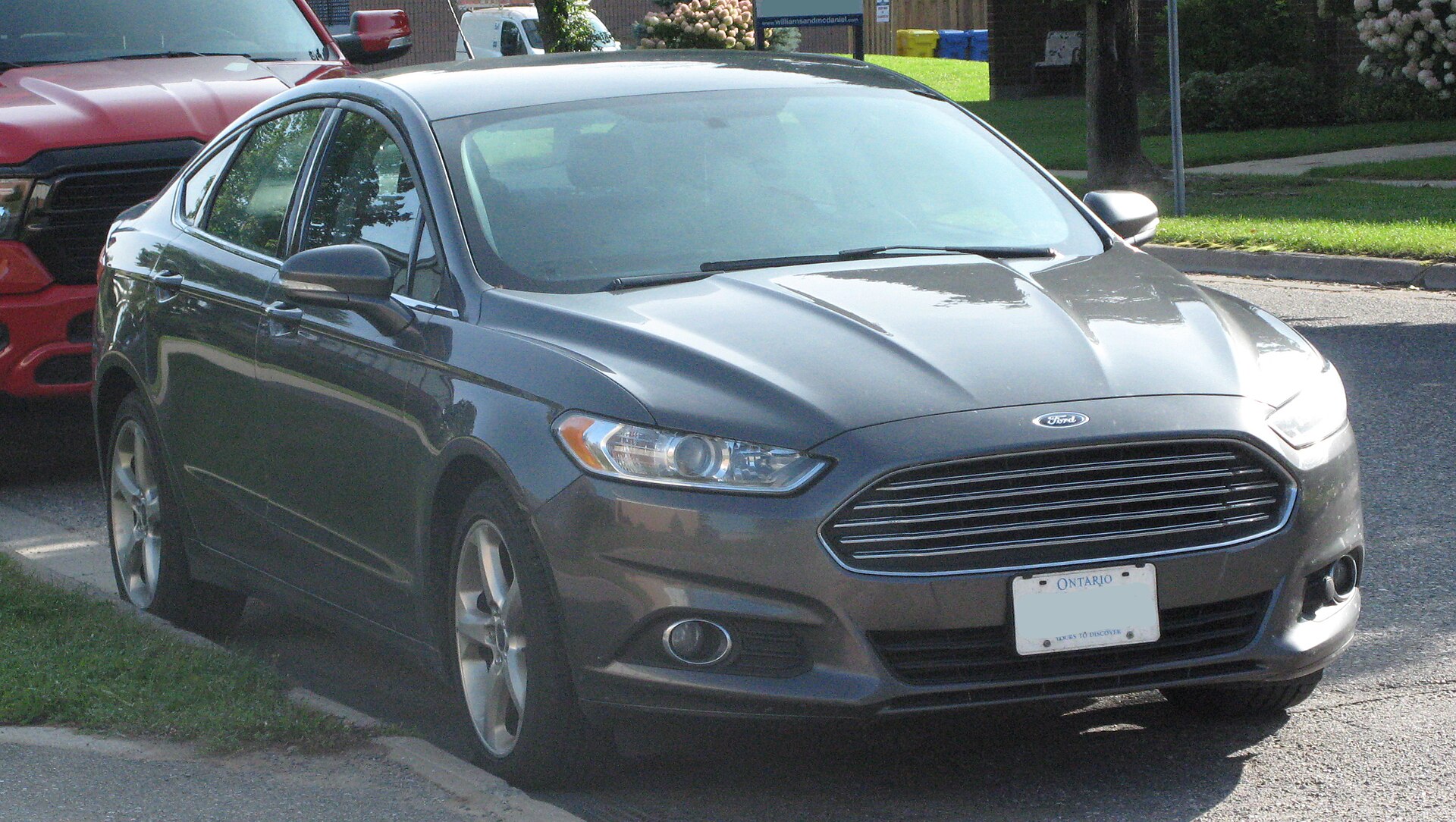 A gray Ford Fusion SE sedan, front three-quarter view