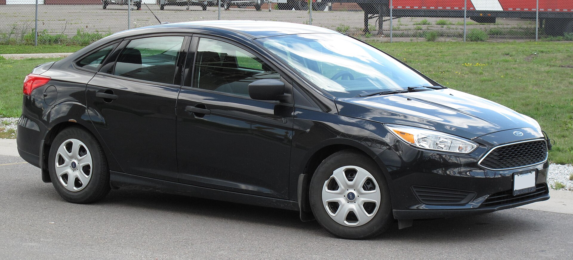 A black Ford Focus sedan, front three-quarter view