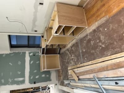 Kitchen renovation in progress with partially installed cabinetry