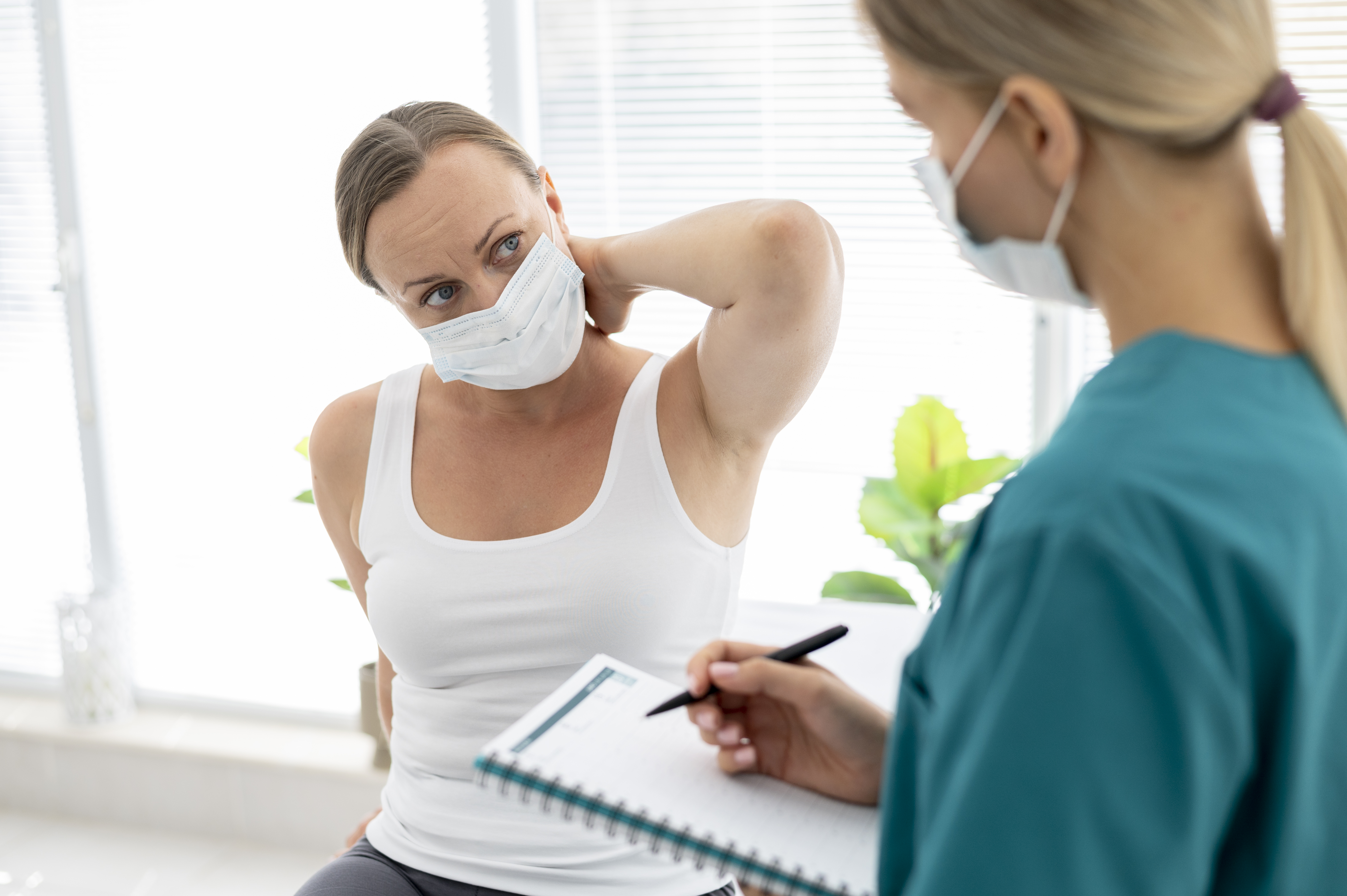 Young physiotherapist helping a patient with back problems