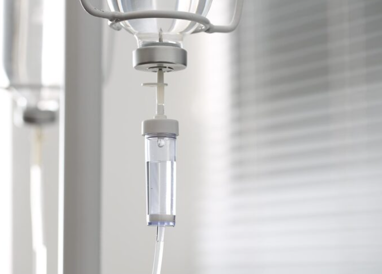 Iv drip chamber against blurred light background