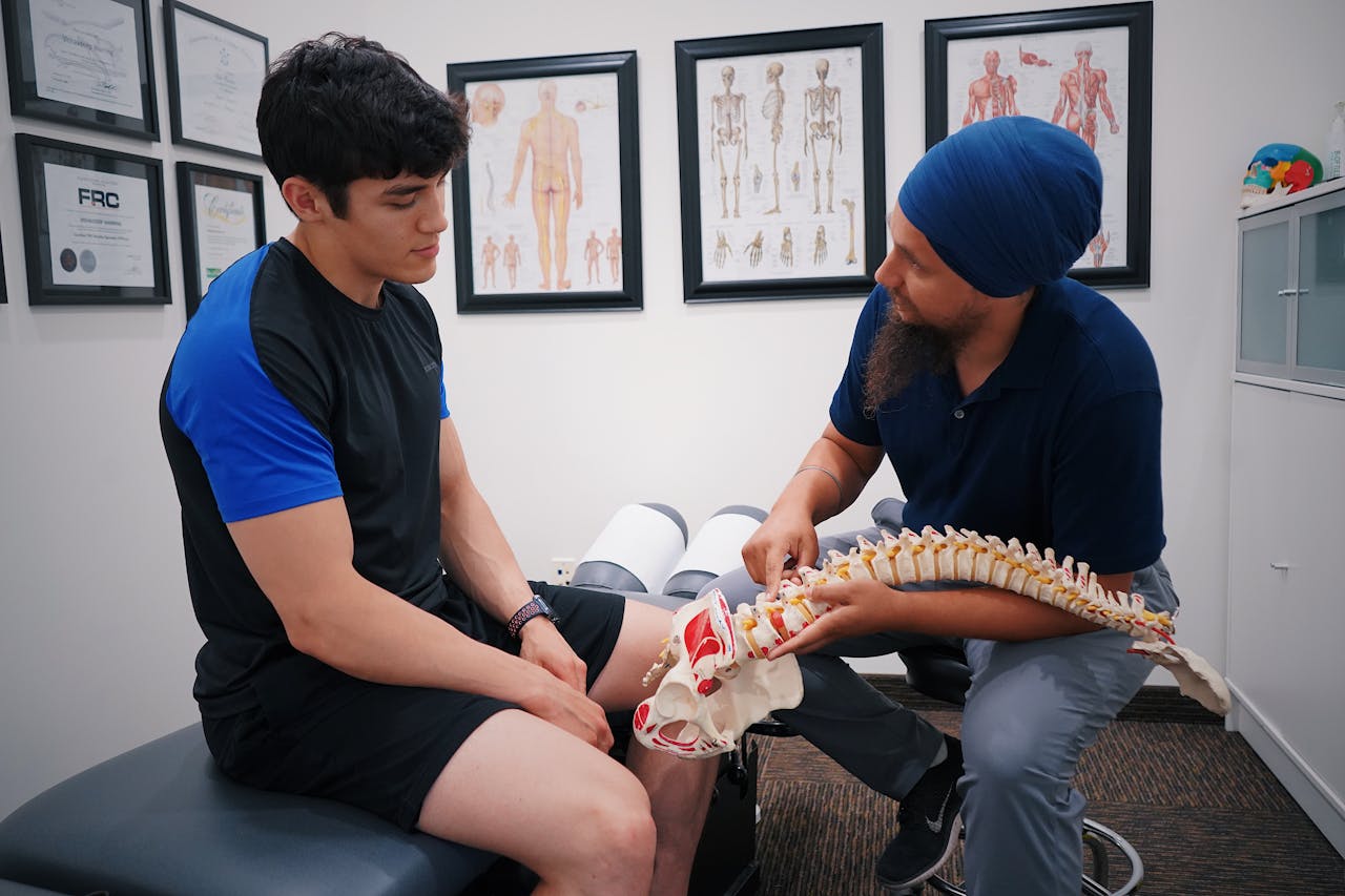 A patient with a doctor for spinal column consultation